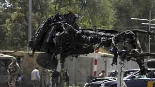 Image: Resolute Support (RS) forces remove a destroyed vehicle after a car