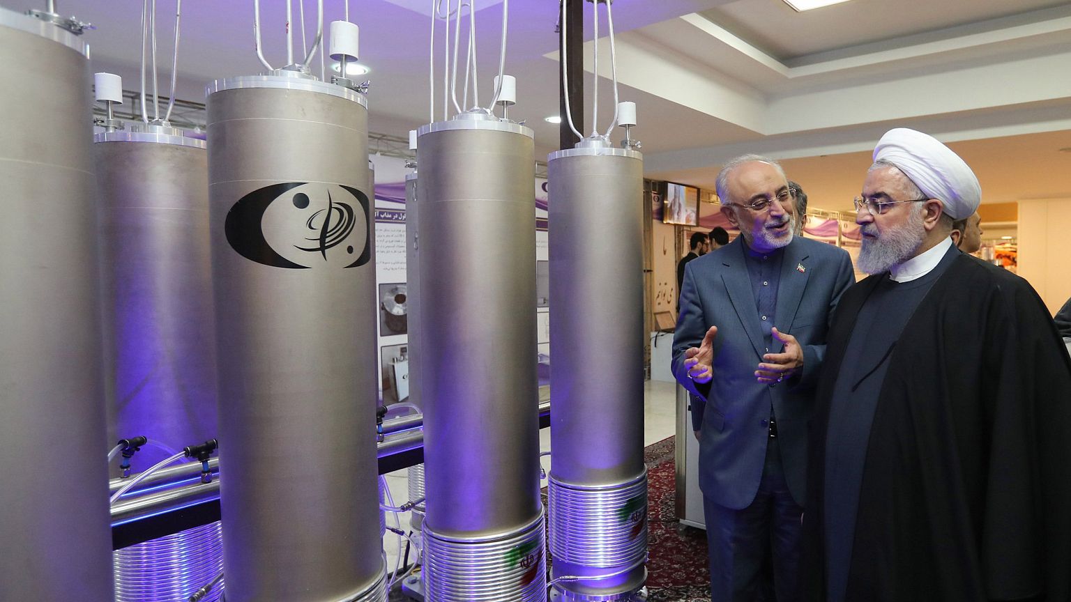 Image: Iranian President Hassan Rouhani, right, listens to head of Iran's n