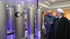 Image: Iranian President Hassan Rouhani, right, listens to head of Iran's n