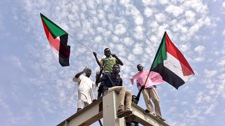 Image: People celebrate the Sudanese government transition to civilian rule
