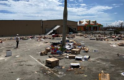 Remains from food and supplies distributed by Abaco Groceries the day after the storm passed in a parking lot on Sept. 8, 2019.