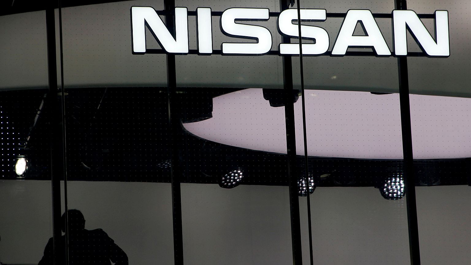 Image: FILE PHOTO: Man is silhouetted at a show room of Nissan Motor Co. in