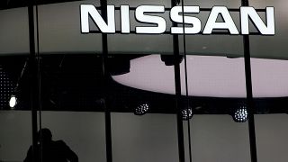 Image: FILE PHOTO: Man is silhouetted at a show room of Nissan Motor Co. in