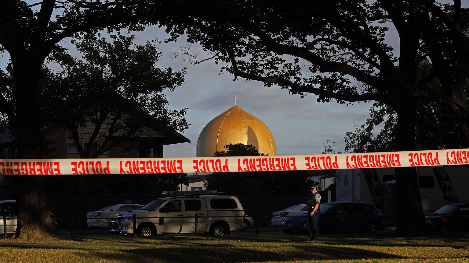 Image: A police officer stands guard in front of the Masjid Al Noor mosque 