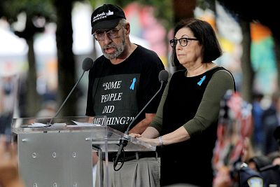 Nick Haros, left, reads victim names during ceremonies commemorating the 18th anniversary of the Sept. 11 terrorist attacks in Lower Manhattan on Sept. 11, 2019.