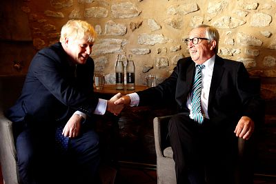 E.U. Commission president Jean-Claude Juncker shakes hands with British PM Boris Johnson prior to their meeting in Luxembourg on Monday. 