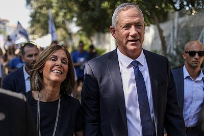 Leader of the Israeli Blue and White party and former IDF chief of staff, Benny Gantz, from right, and his wife Revital Gantz, leave a polling station after casting their votes during the Israeli parliamentary elections in Rosh Haayin, Israel.