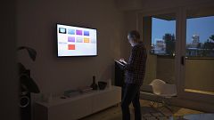 Image: A man using smart TV apps via a digital tablet.