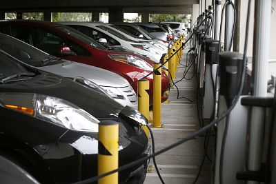 Electric cars sit charging in a parking garage at the University of California, Irvine on Jan. 26, 2015.