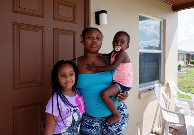 Monique Mottley, 30, with her 3-year-old daughter and 7-year old niece, outside Mottley\'s home at the Okeechobee Center.