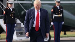 Image: President Donald Trump prepares to speak to reporters before boardin