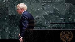 Image: British Prime Minister Boris Johnson walks off after speaking at the