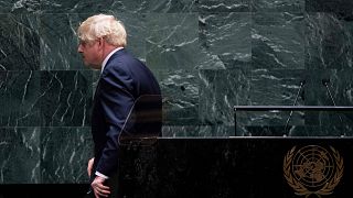 Image: British Prime Minister Boris Johnson walks off after speaking at the