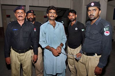 Pakistani police officers present Waseem Azeem, the brother of slain model Qandeel Baloch in Multan, Pakistan, in 2016. 