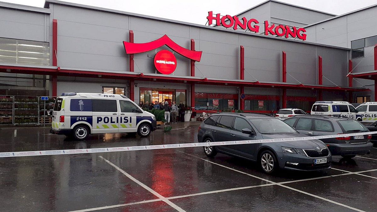 Image: Police cars stand on the blocked grounds of the Hermanni shopping ce