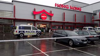 Image: Police cars stand on the blocked grounds of the Hermanni shopping ce