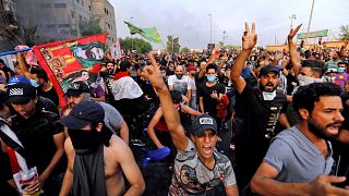 Image: Demonstrators gesture at a protest over unemployment, corruption and