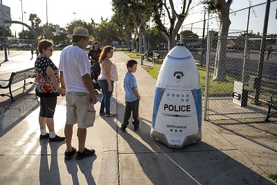 A group of people check out HP RoboCop in Salt Lake Park on Sept. 19, 2019.