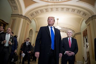 President Donald Trump accompanied by Senate Majority Leader Mitch McConnell arrives for a Senate Republican policy lunch on Capitol Hill on March 26, 2019.