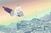 Illustration of man sitting on the ocean's edge with a rainbow projected on