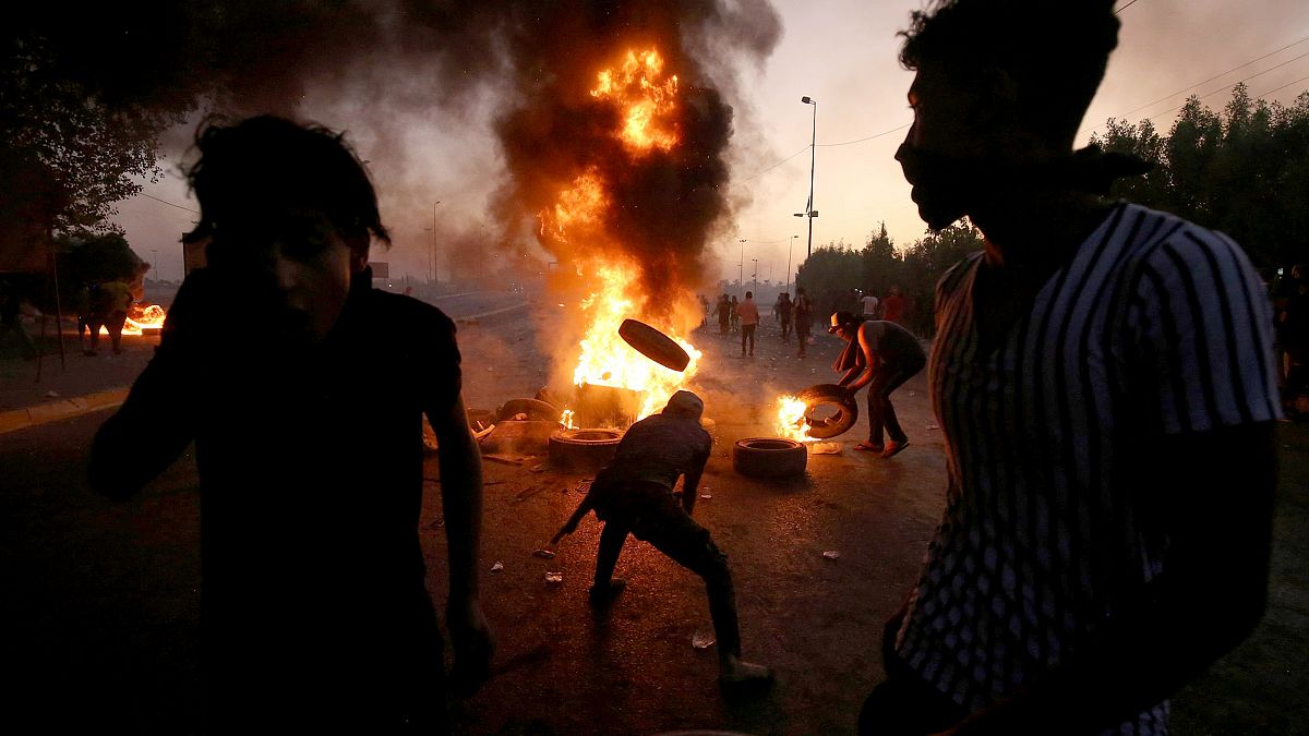 Image: TProtesters burn tires during a demonstration in Baghdad, Iraq, on O