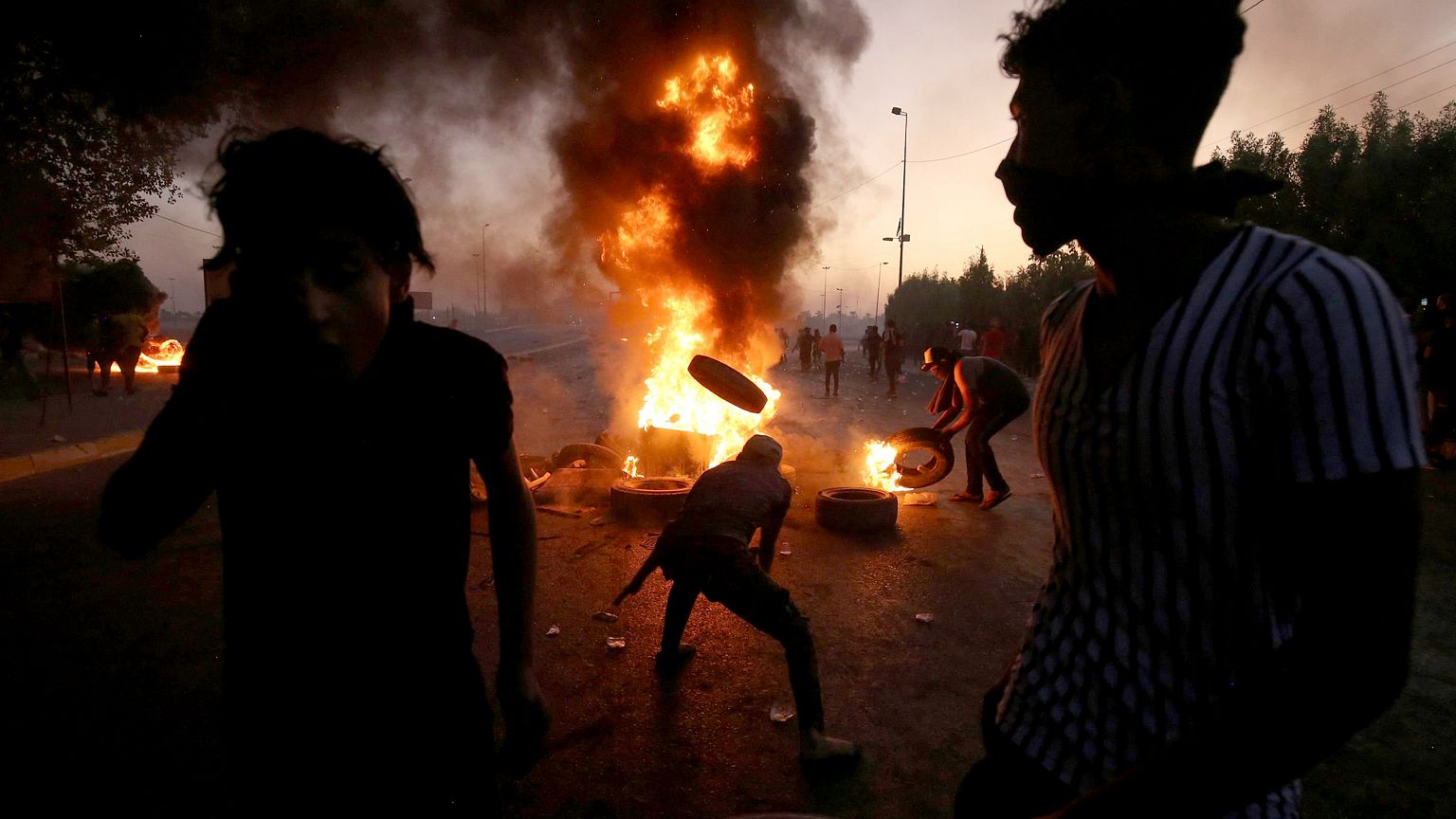 Image: TProtesters burn tires during a demonstration in Baghdad, Iraq, on O