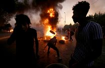 Image: TProtesters burn tires during a demonstration in Baghdad, Iraq, on O
