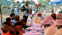 Image: A woman and child wait to receive the Ebola vaccination in Goma, Dem