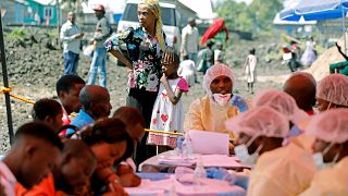 Image: A woman and child wait to receive the Ebola vaccination in Goma, Dem