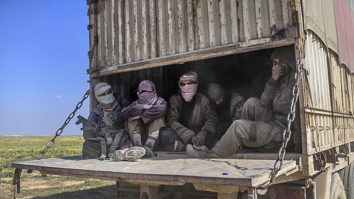 Image: A truck carrying men, identified as Islamic State group fighters who