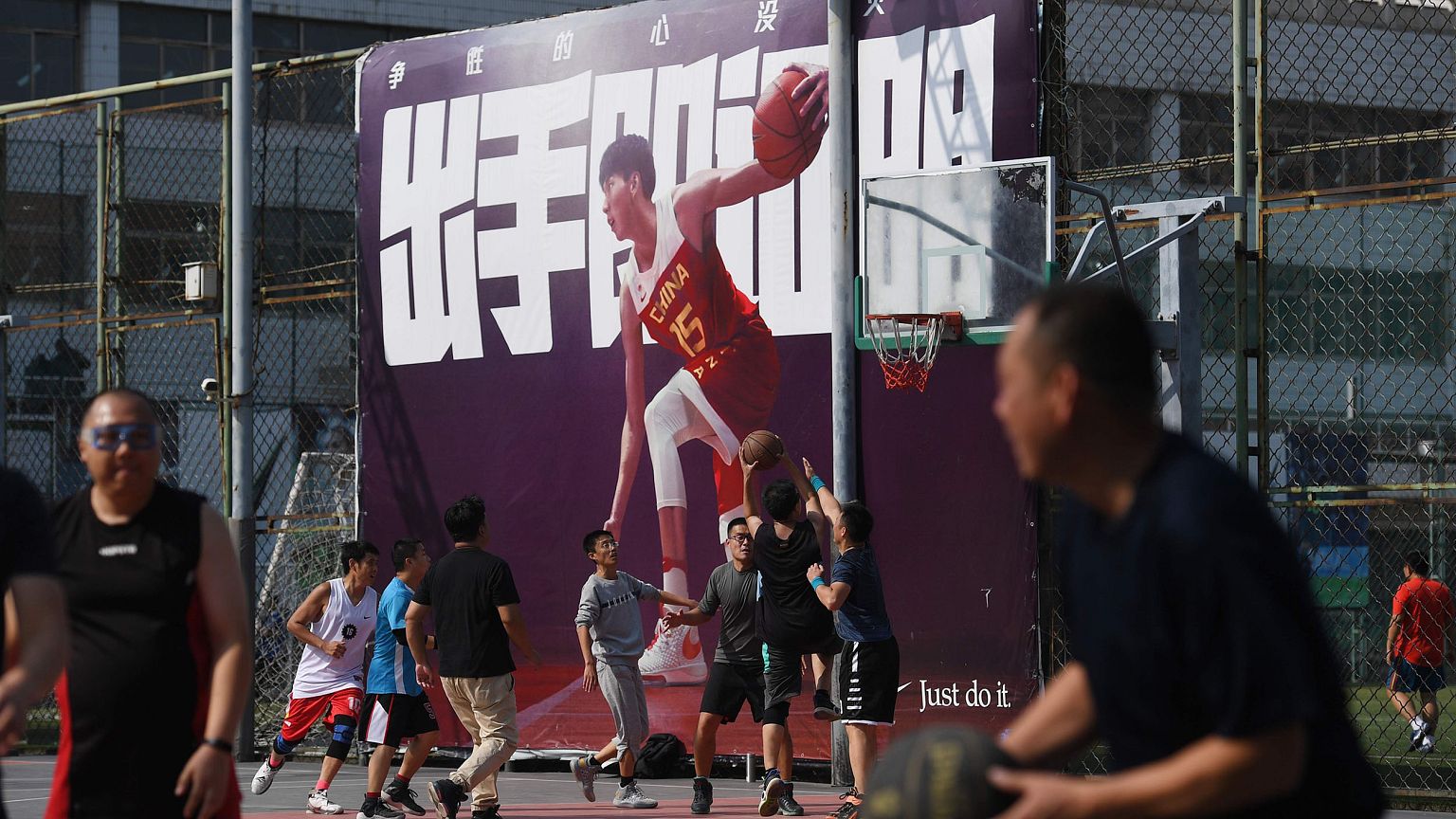 Image: People play basketball at an outdoor court in Beijing on Oct. 9, 201