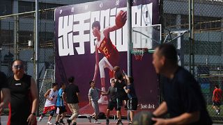 Image: People play basketball at an outdoor court in Beijing on Oct. 9, 201