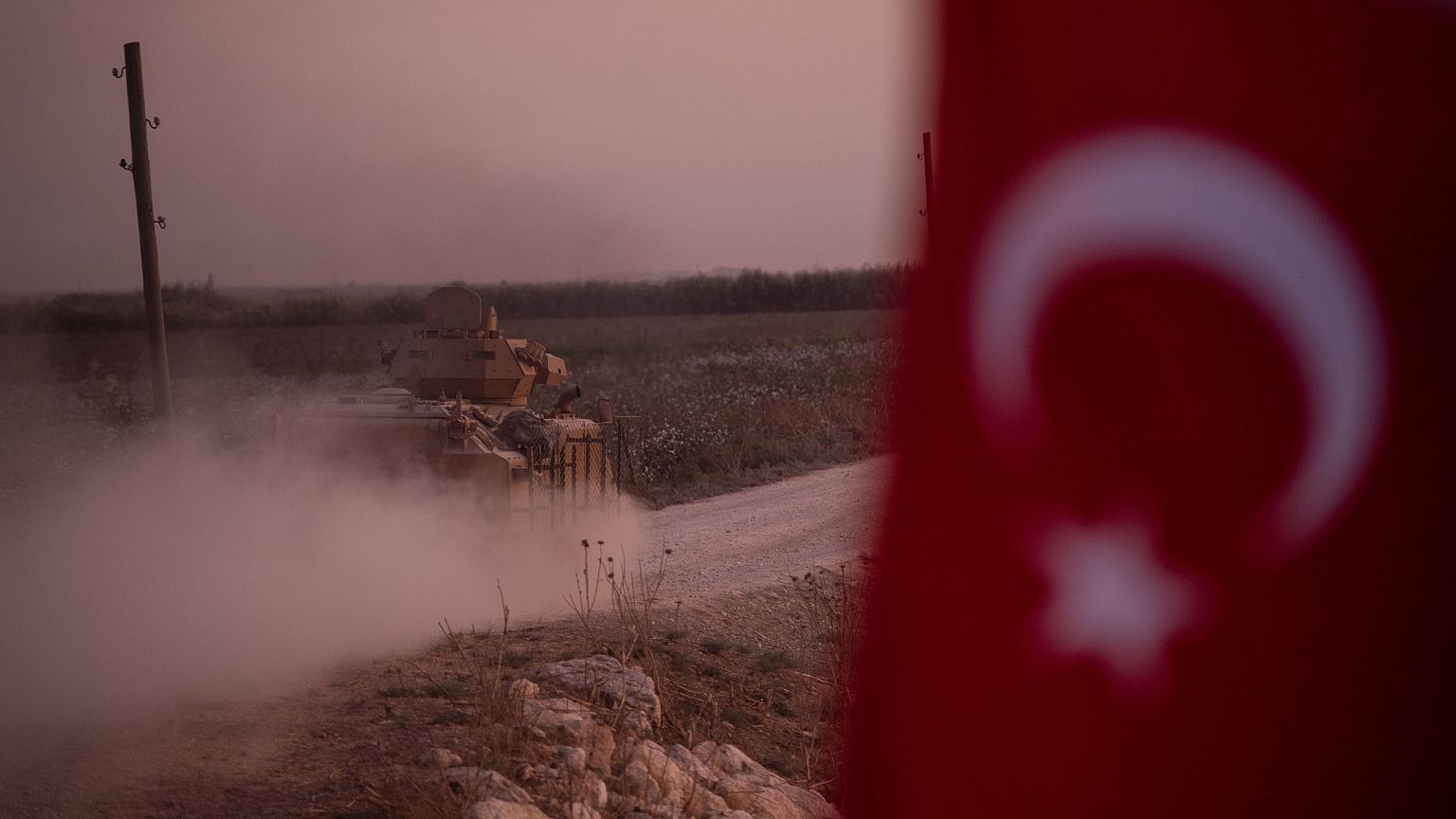 Image: A Turkish armored vehicle prepares to cross the border into Syria on