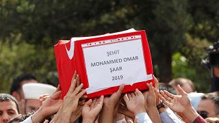 Image: People carry the Turkish flag-wrapped coffin of 9-month-old baby boy
