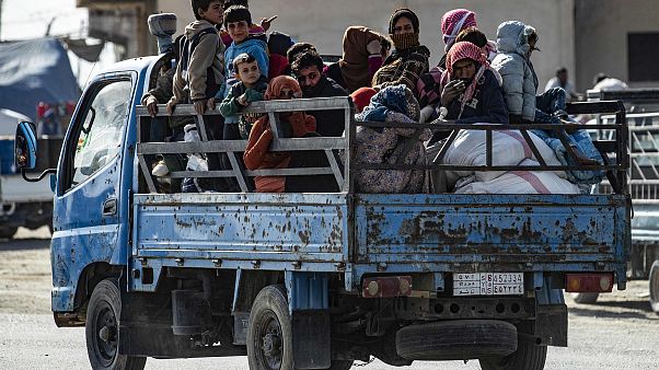 Image: Syrian families fleeing the battle zone between Turkey-led forces an Image: Syrian families fleeing the battle zone between Turkey-led forces an