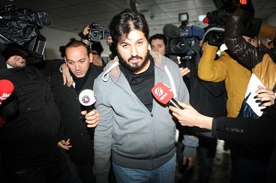 Businessman Reza Zarrab is surrounded by journalists as he arrives at a police center in Istanbul on Dec. 17, 2013.