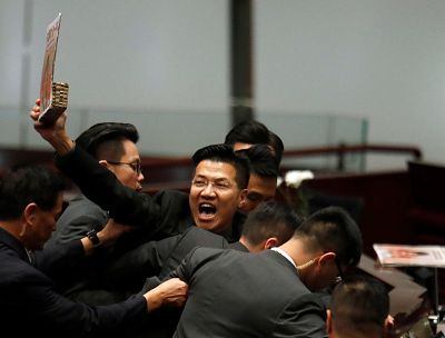 A pro-democracy lawmaker is escorted by security from the Legislative Council, as Hong Kong\'s Chief Executive Carrie Lam takes questions from lawmakers regarding her policy address, in Hong Kong, China Oct. 17, 2019.