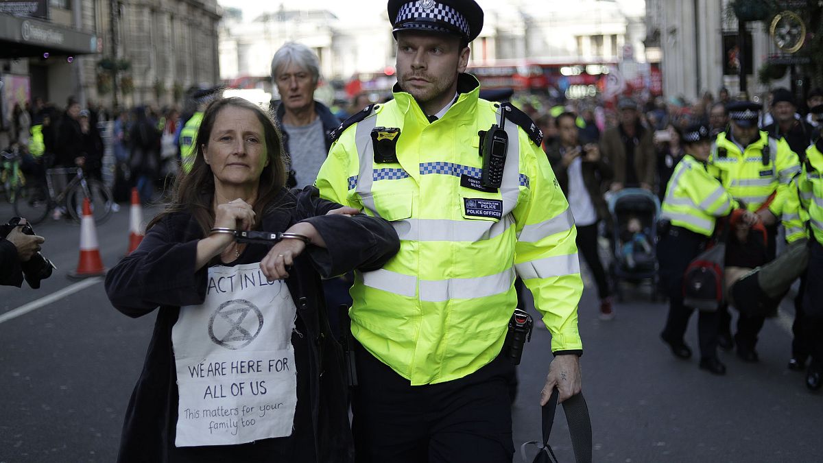 Image: Police officers remove Extinction Rebellion climate change protester
