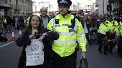 Image: Police officers remove Extinction Rebellion climate change protester