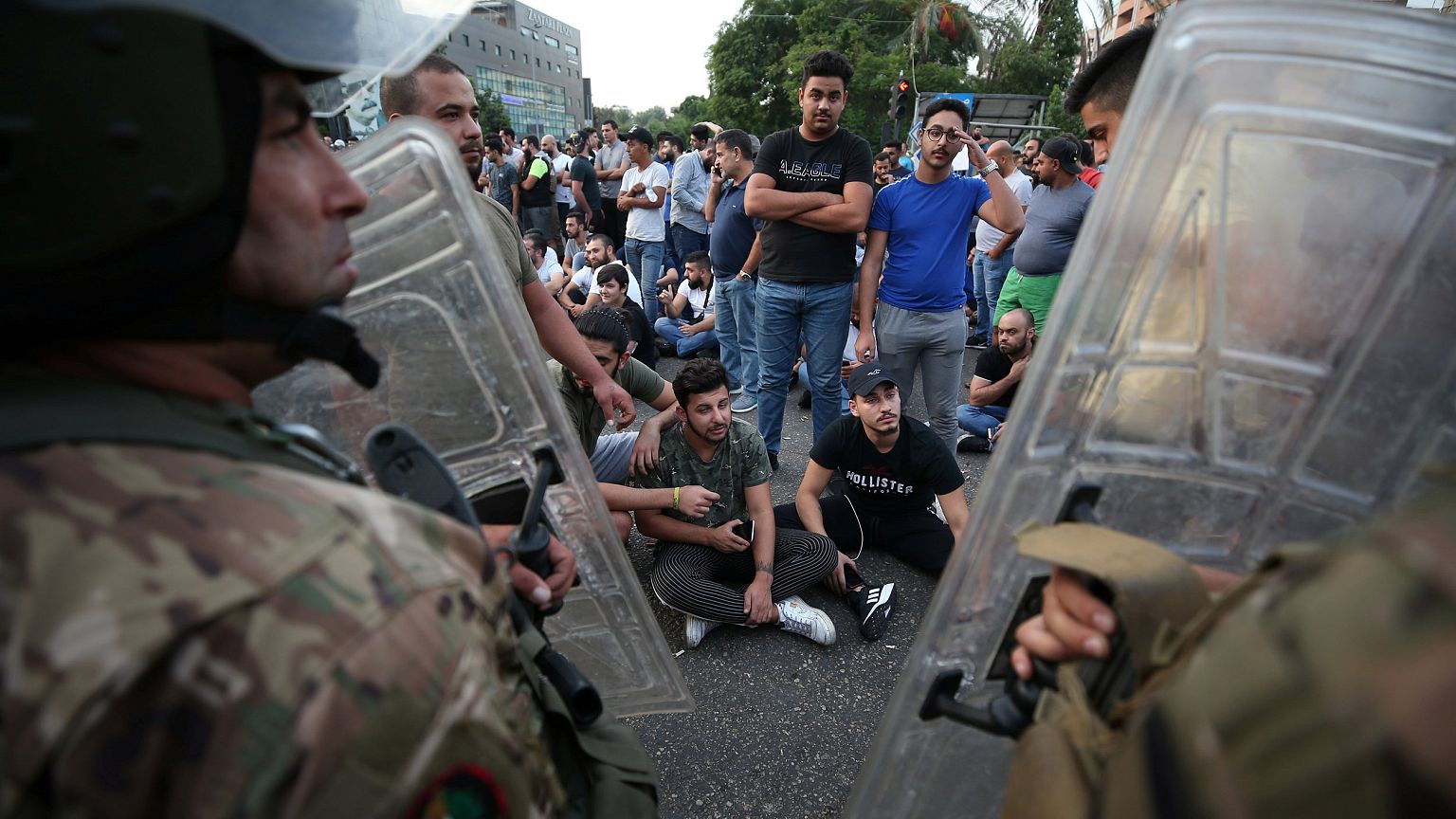 Image: Demonstrators gather during a protest over deteriorating economic si