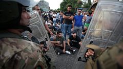 Image: Demonstrators gather during a protest over deteriorating economic si
