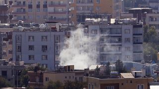 Image: Smoke billows from targets in Ras al-Ayn, Syria, caused by shelling 