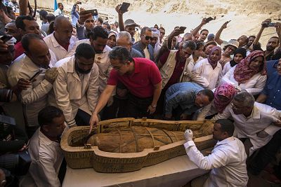 Egypt\'s Antiquities Minister Khaled el-Enany, and Mostafa Waziri, the Secretary General of the Supreme Council of Antiquities, surround a sarcophagus belonging to a man in front Hatshepsut Temple at Valley of the Kings in Luxor on Oct. 19, 2019.