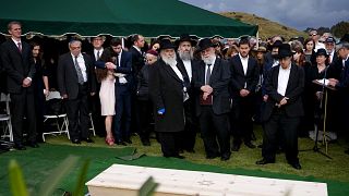 Image: Hannah Kaye, along with Jewish community leaders and mourners, stand