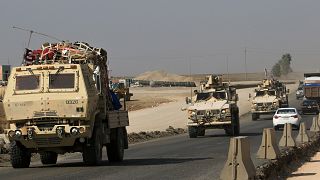 Image: A convoy of U.S. vehicles at the Iraqi-Syrian border crossing in the