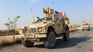 Image: A convoy of U.S. vehicles at the Iraqi-Syrian border crossing in the