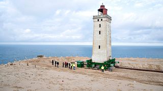 Image: People work on the lighthouse in Rubjerg Knude that is being moved a