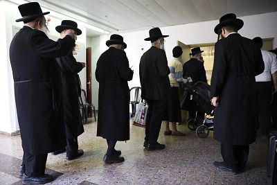 Ultra orthodox Jews line up to vote in Bnei Brak, Israel, Tuesday, Sept. 17, 2019. Israelis began voting Tuesday in an unprecedented repeat election that will decide whether longtime Prime Minister Benjamin Netanyahu stays in power despite a looming indictment on corruption charges