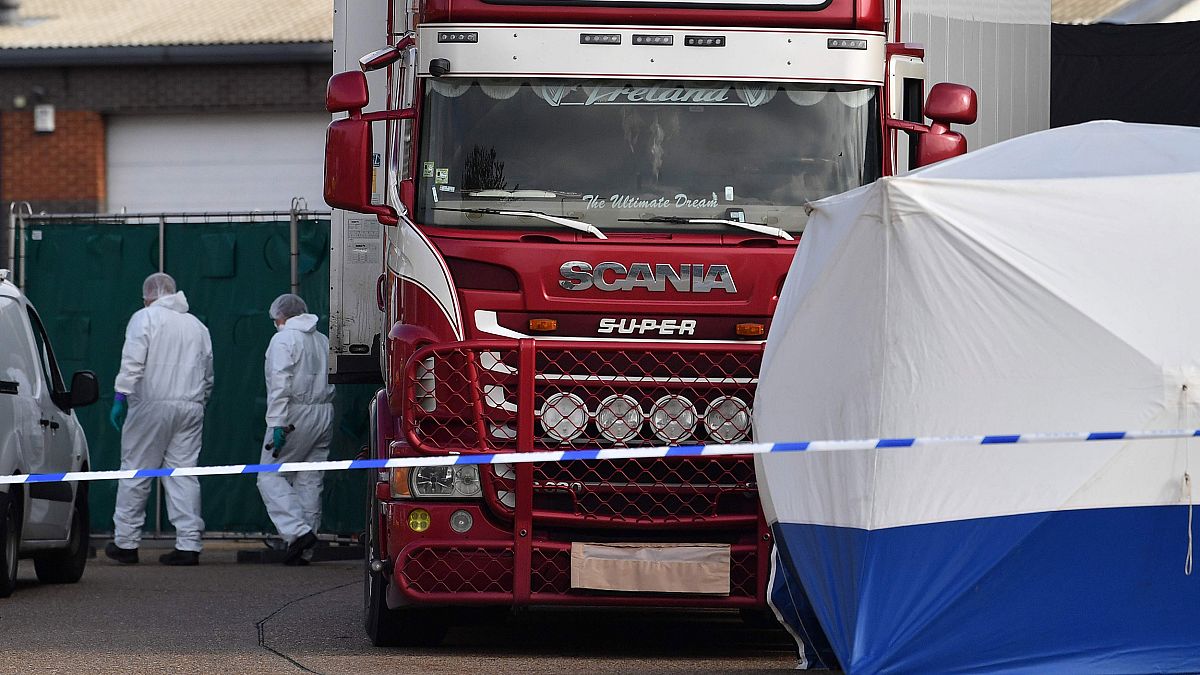 Image: Police officers in a forsensic suits at the scene of a lorry found t