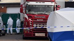 Image: Police officers in a forsensic suits at the scene of a lorry found t